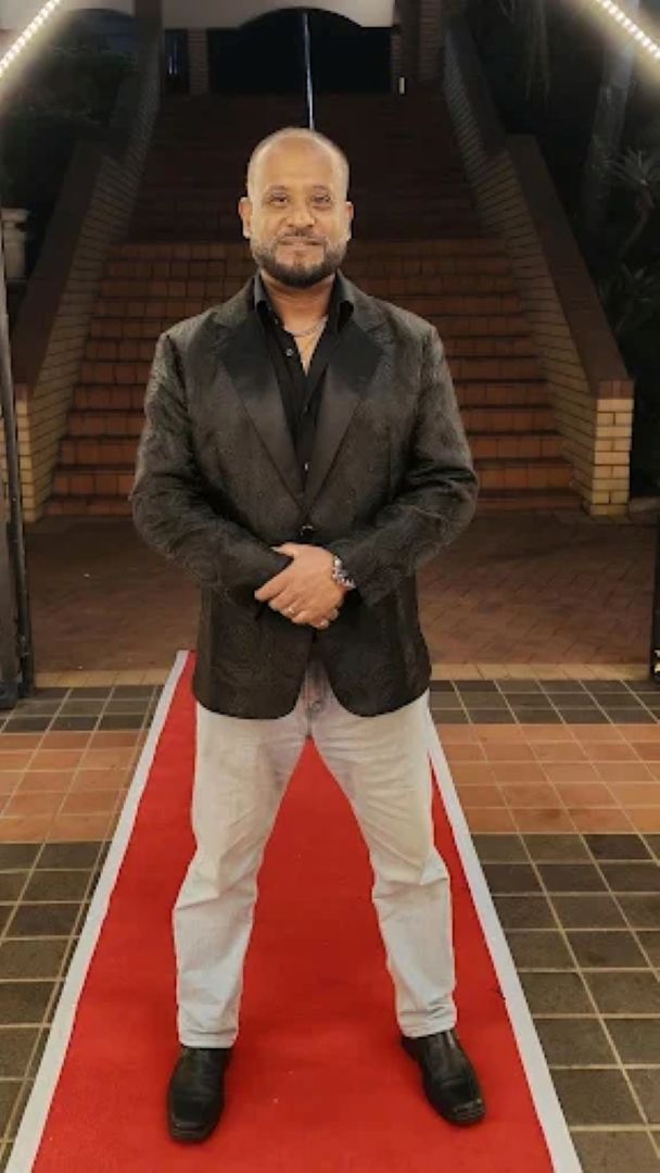 Nichal Sarawan in formal jacket, portrait for corporate hosting engagements