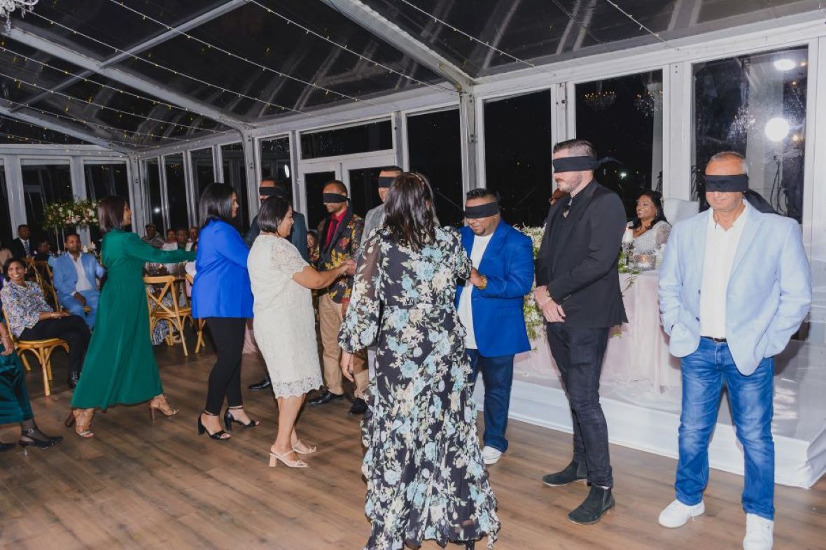 Guests playing a blindfolded reception game led by Vanish Media